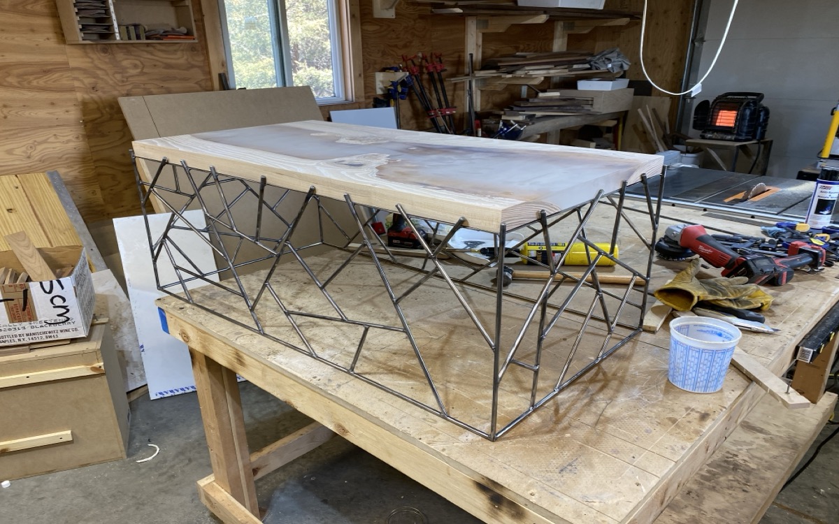 Brazed steel lattice base dry-fit with raw walnut top in the workshop