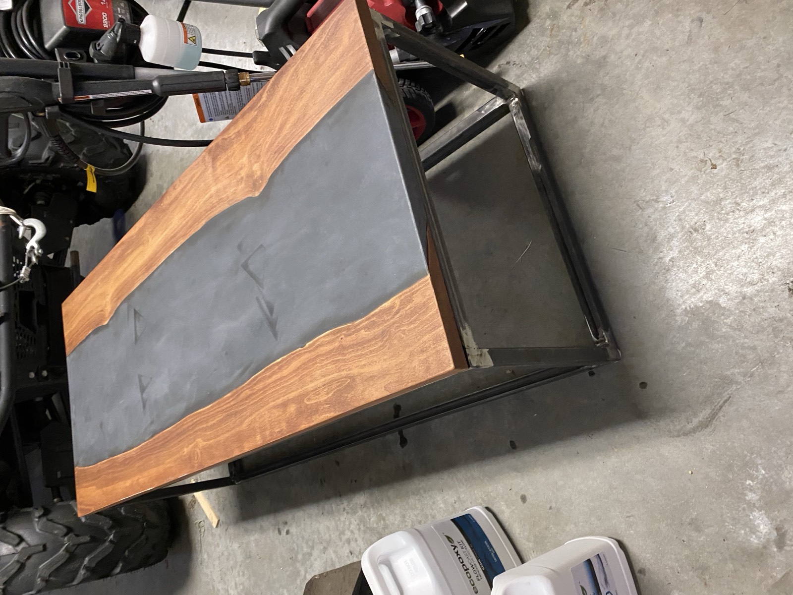 Coffee table in the workshop showing epoxy river top on steel frame