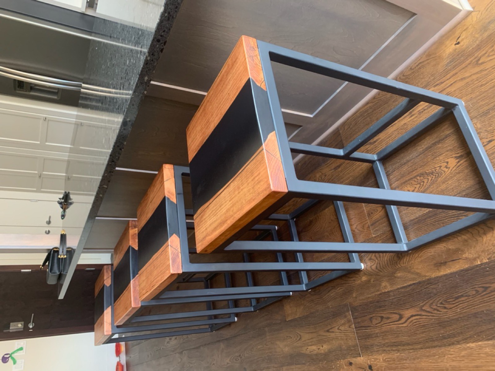 Matching bar stools with epoxy river seats at a kitchen counter