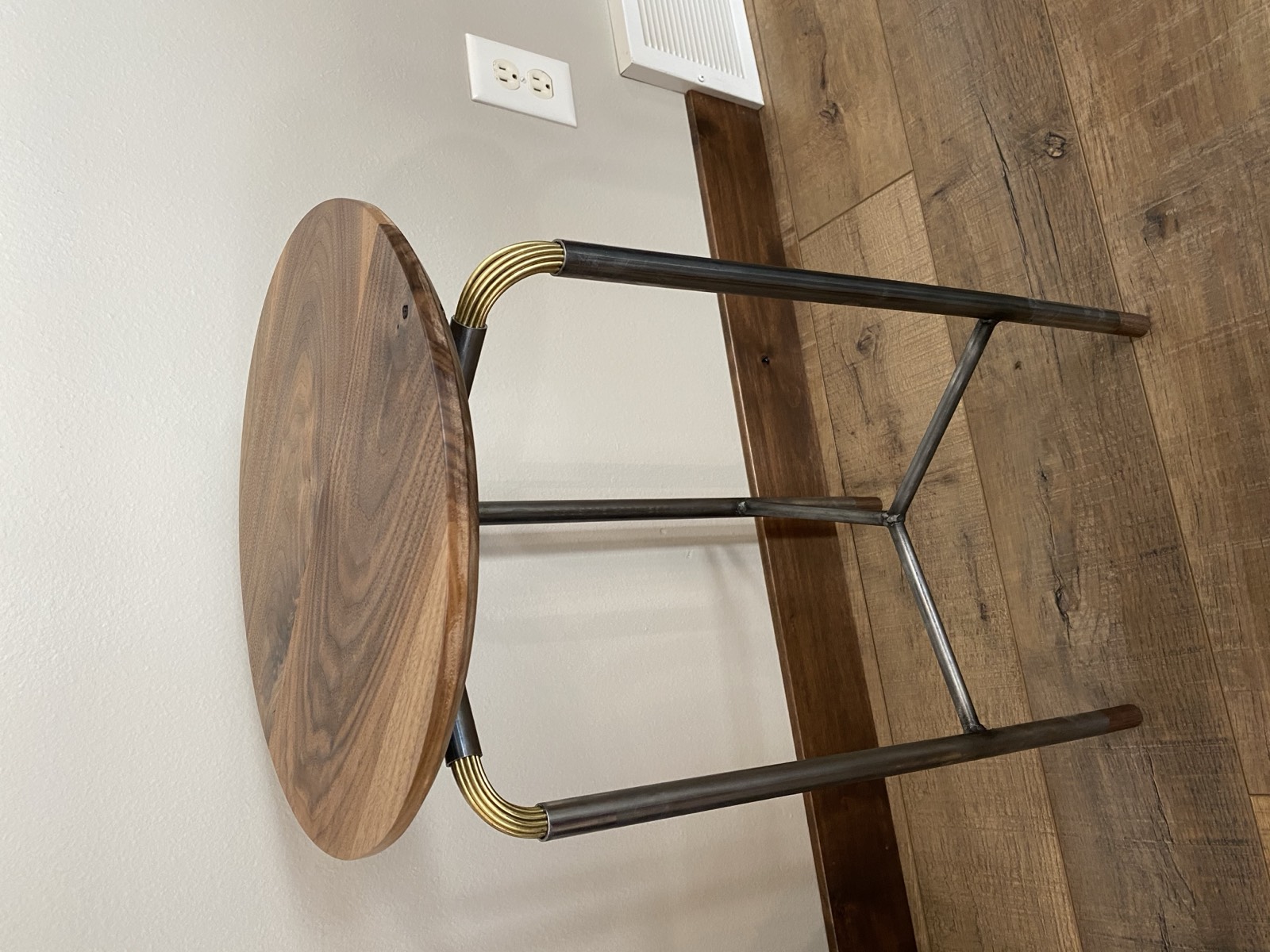 Finished side table with walnut top and brass wire joinery on steel frame
