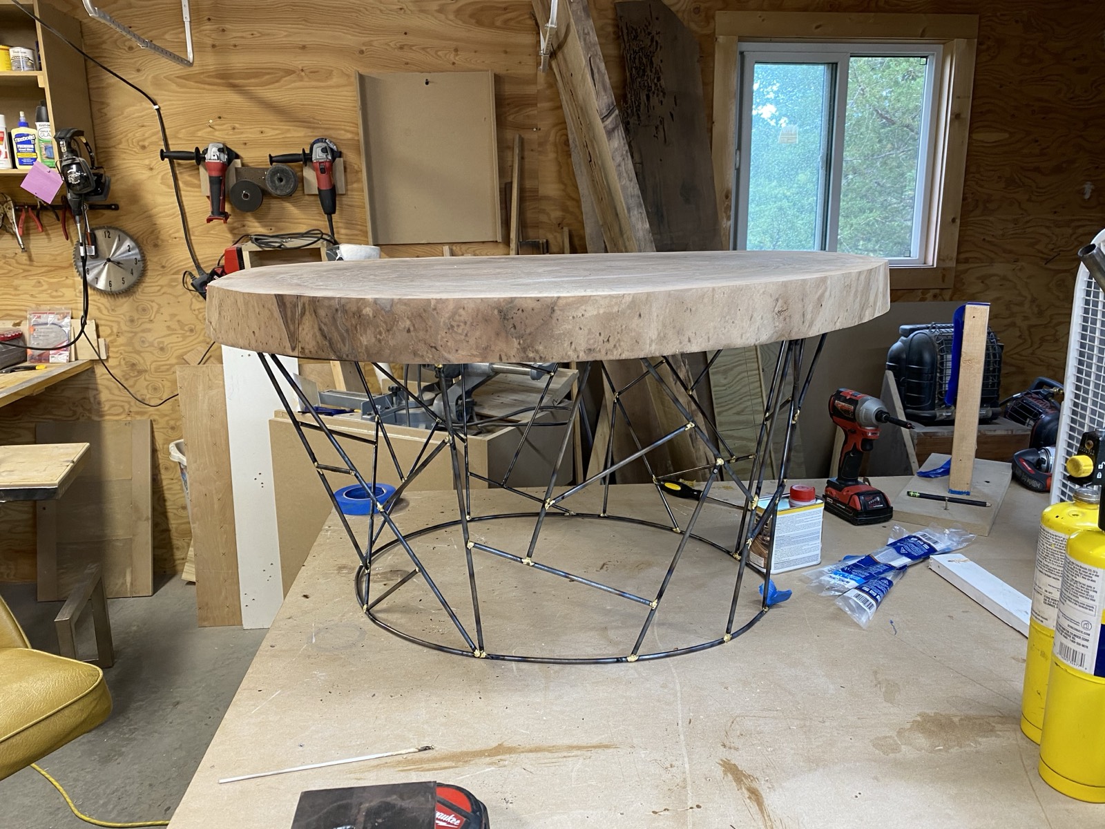 Claro walnut cookie slab on brazed spider web steel base