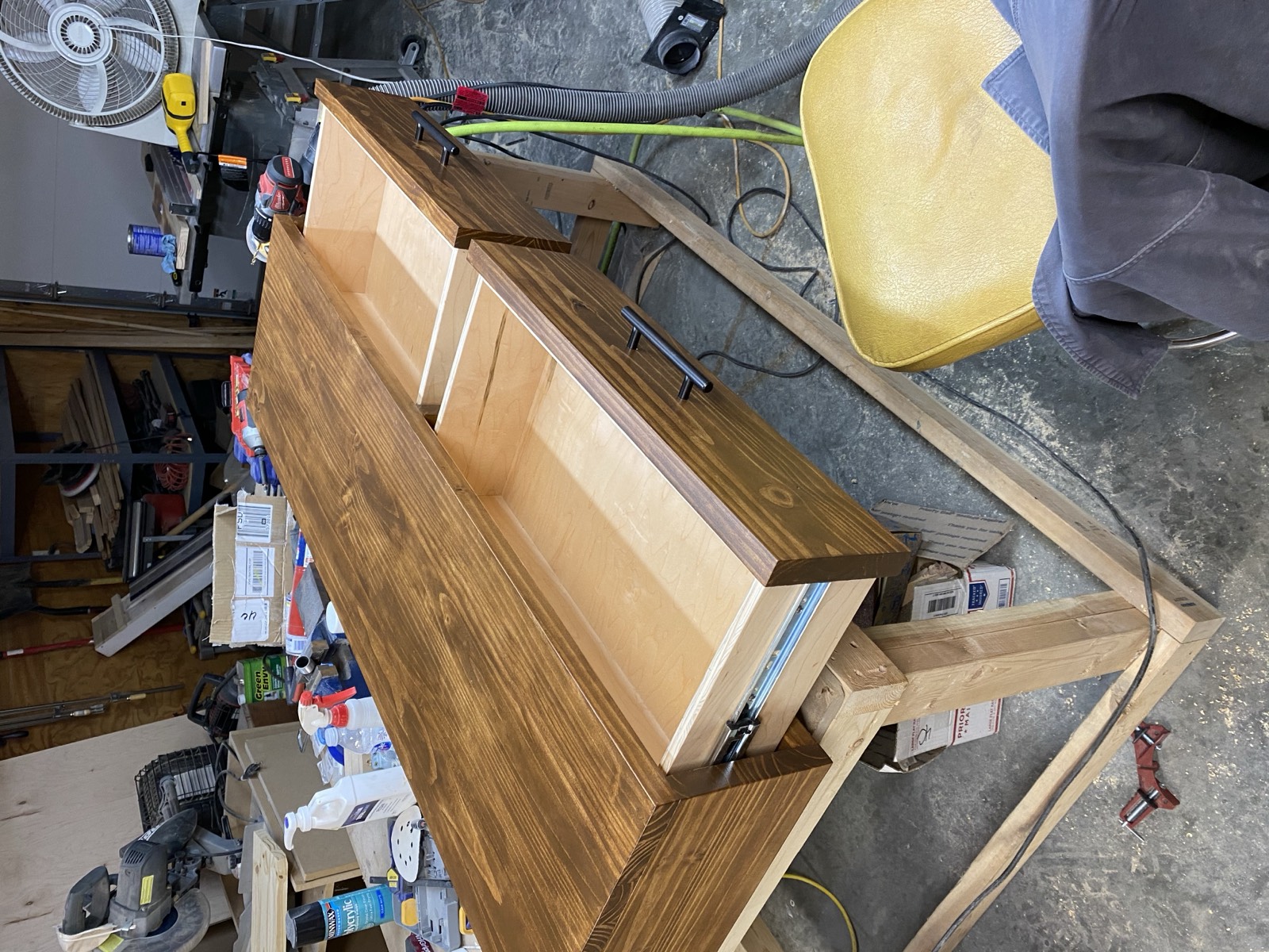 Finished console table with stained wood drawers and steel base