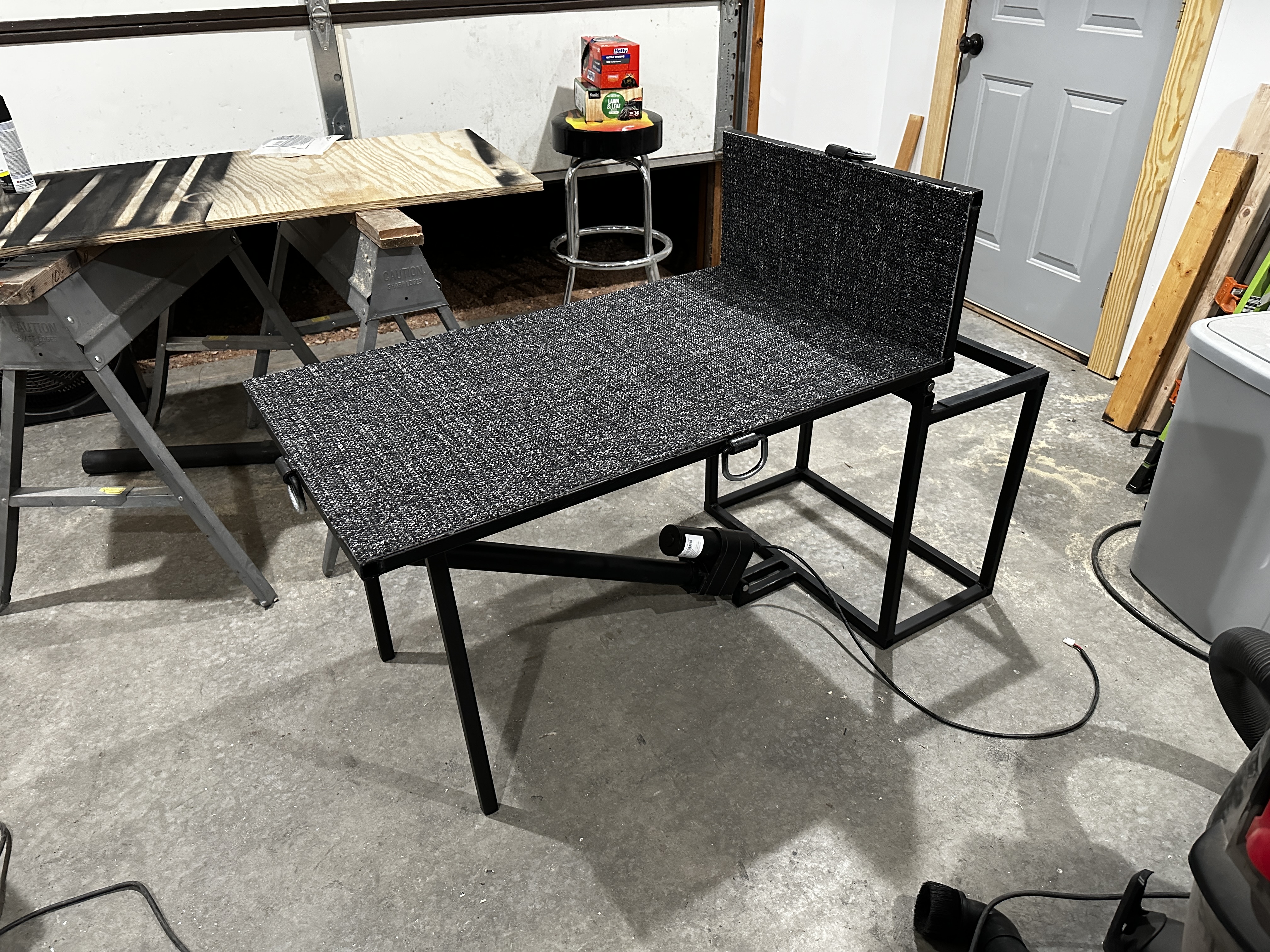 Articulating piano platform with linear actuator in the garage — stores piano vertically for transport