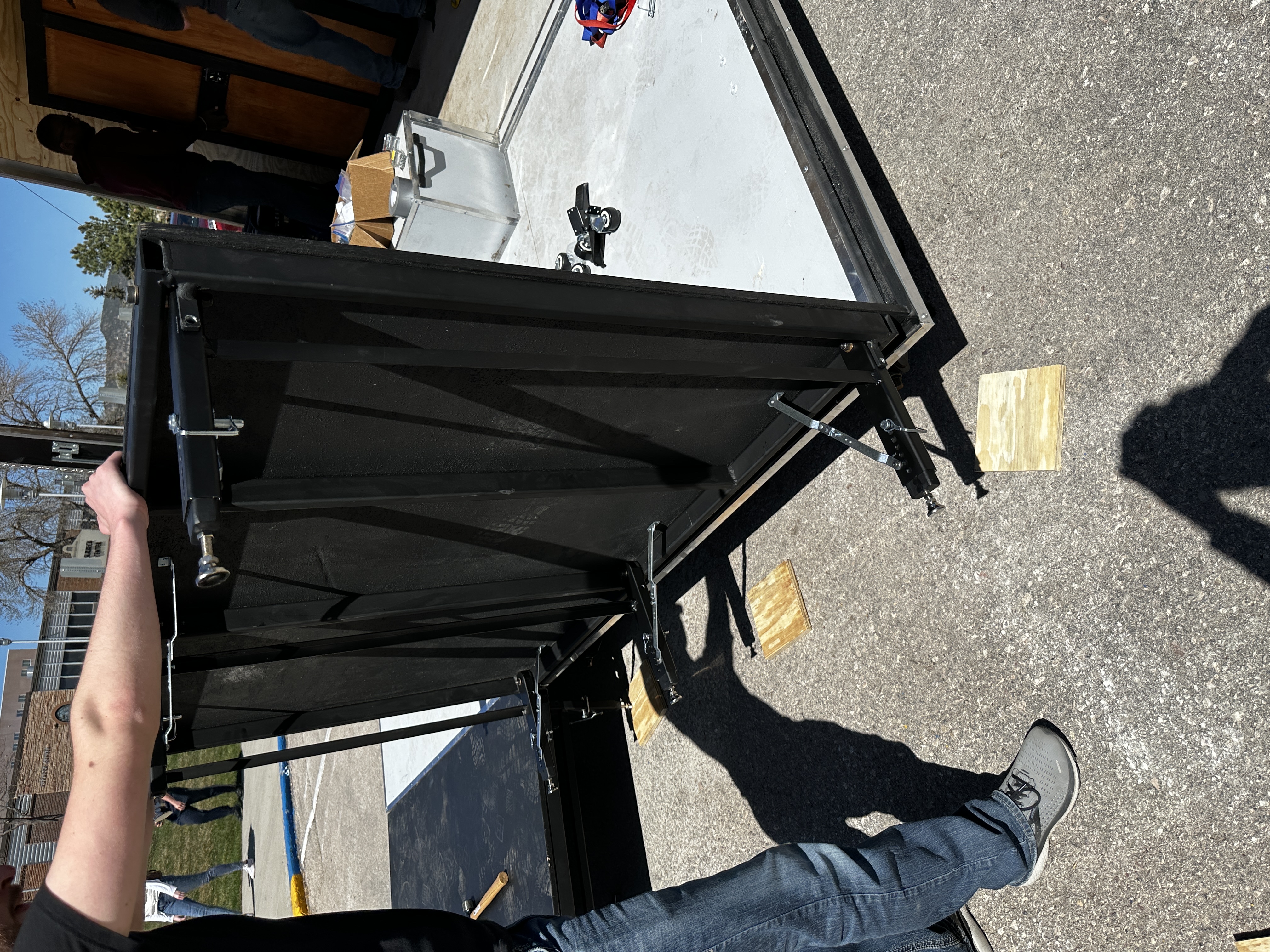 Stage panel being deployed showing the folding leg mechanism
