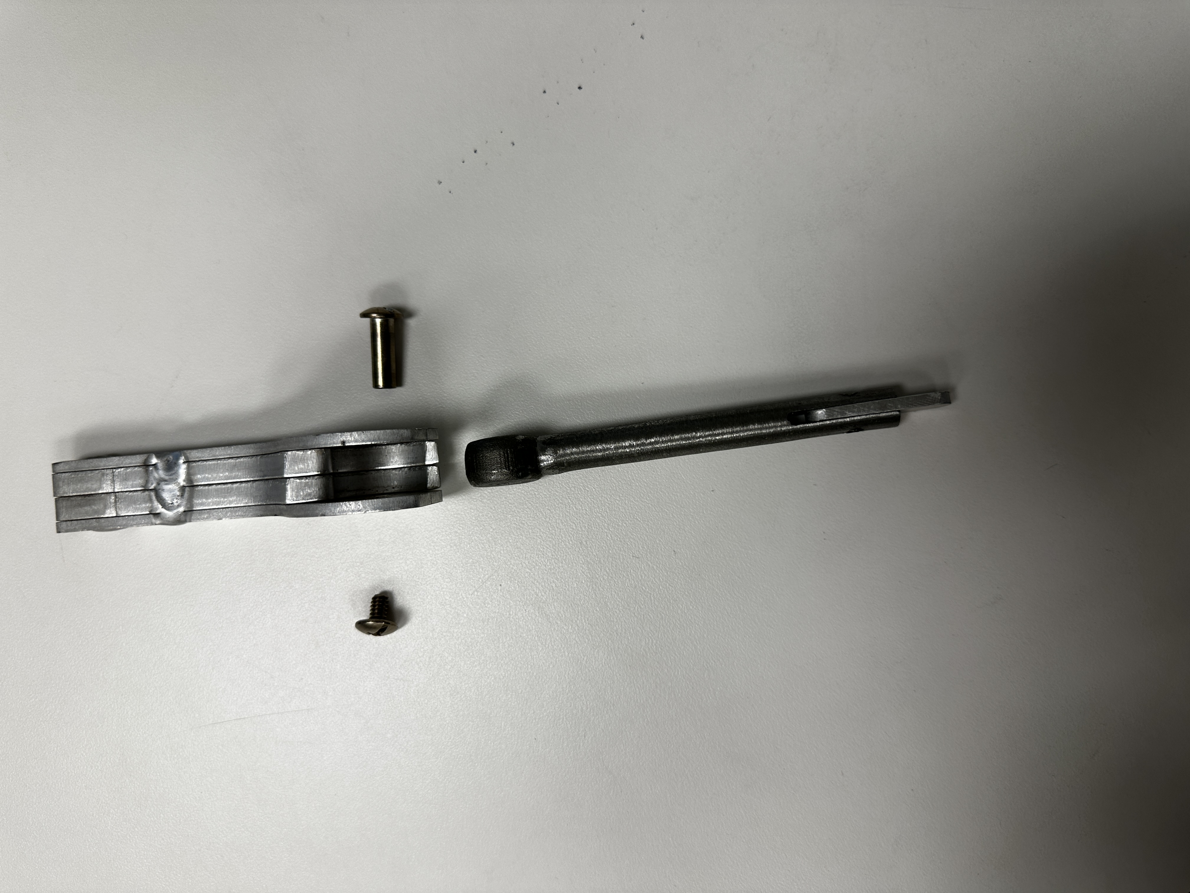Custom-machined cam lock handle disassembled showing the mechanism components