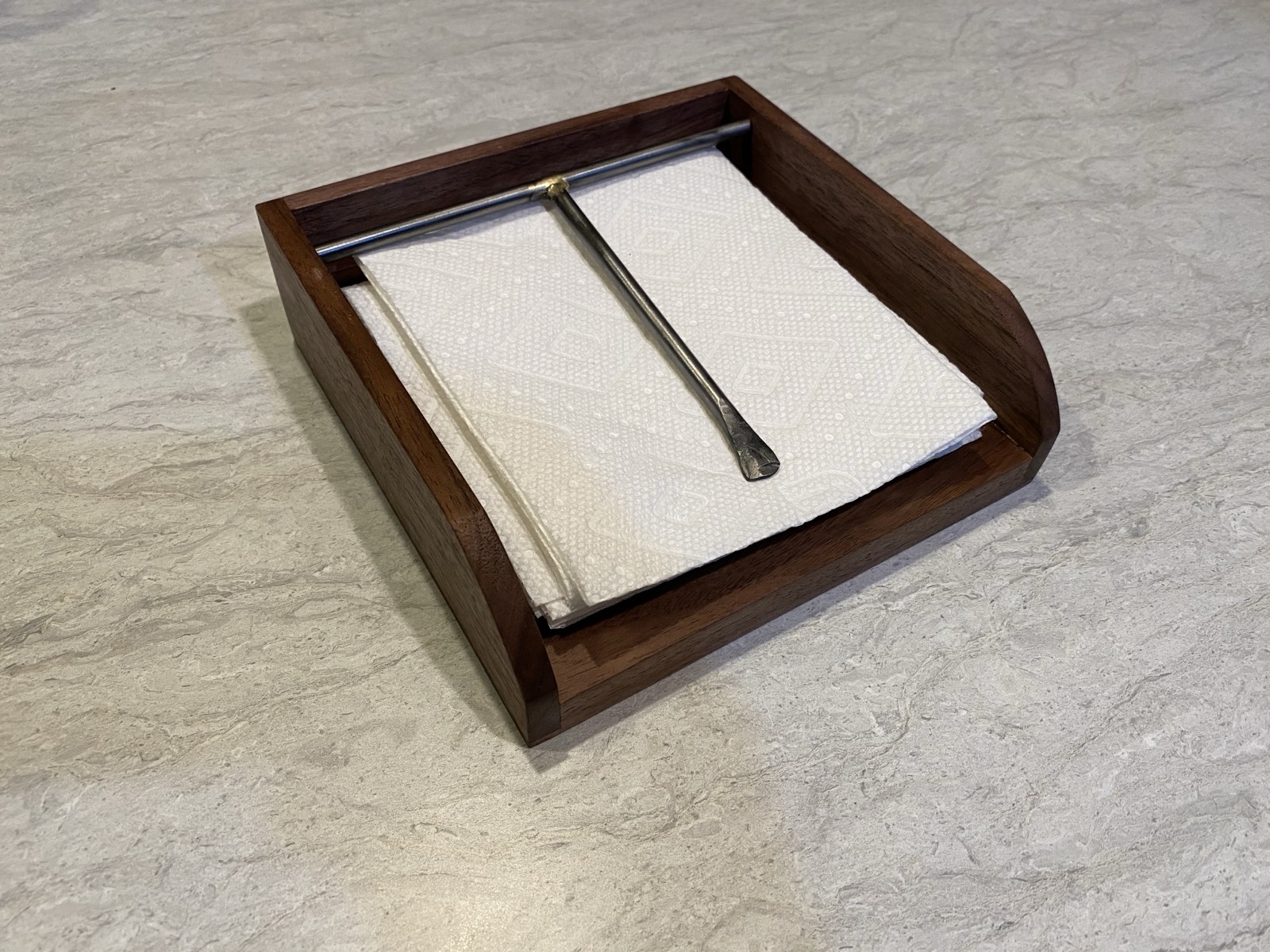 Walnut version of the napkin holder in use with napkins