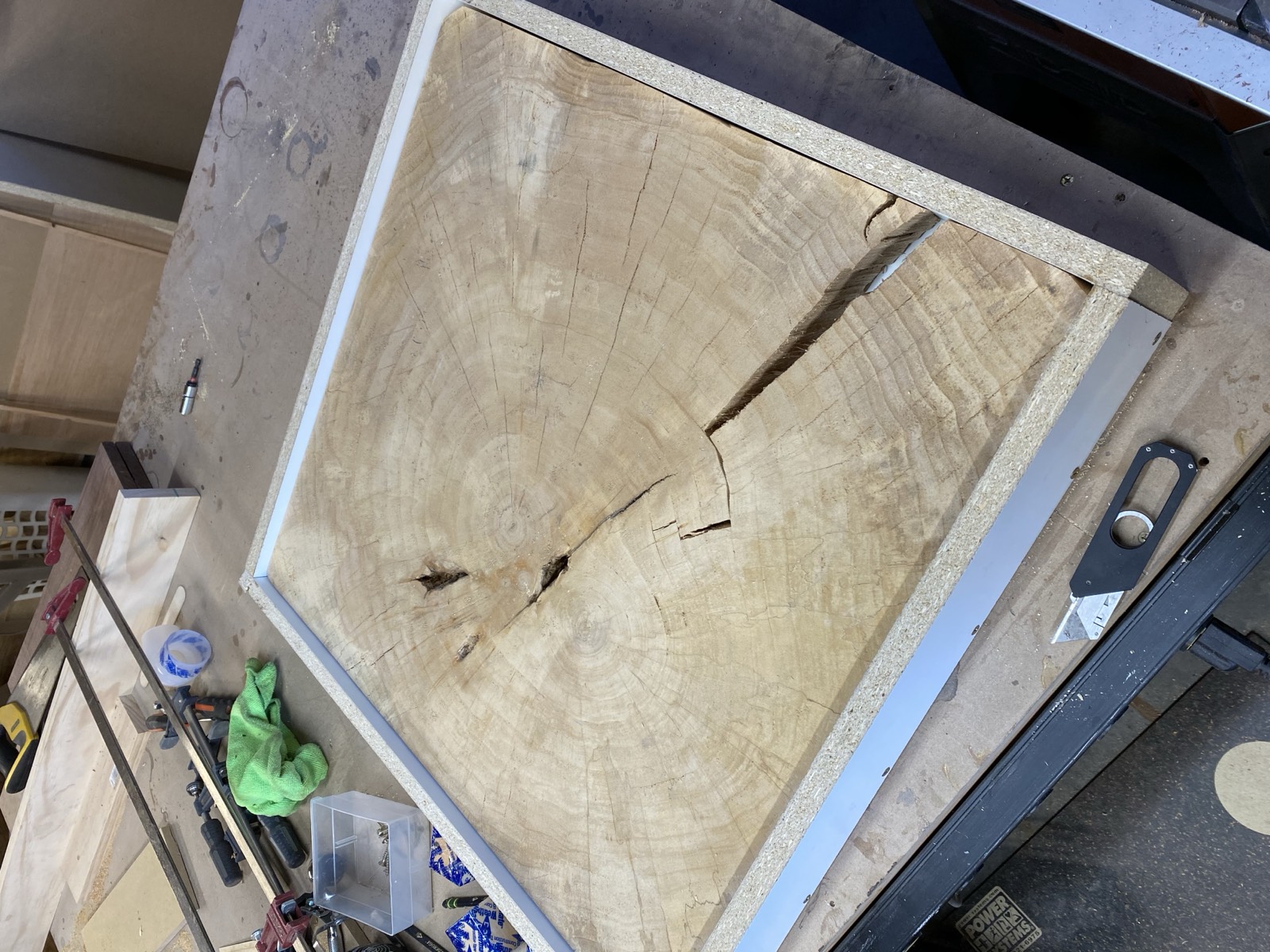 Raw slab in epoxy mold showing voids and cracks before filling