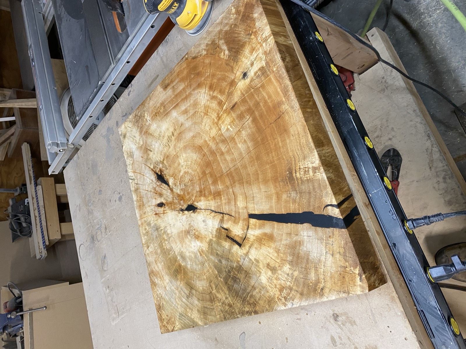 Finished slab top with black epoxy fills sanded smooth