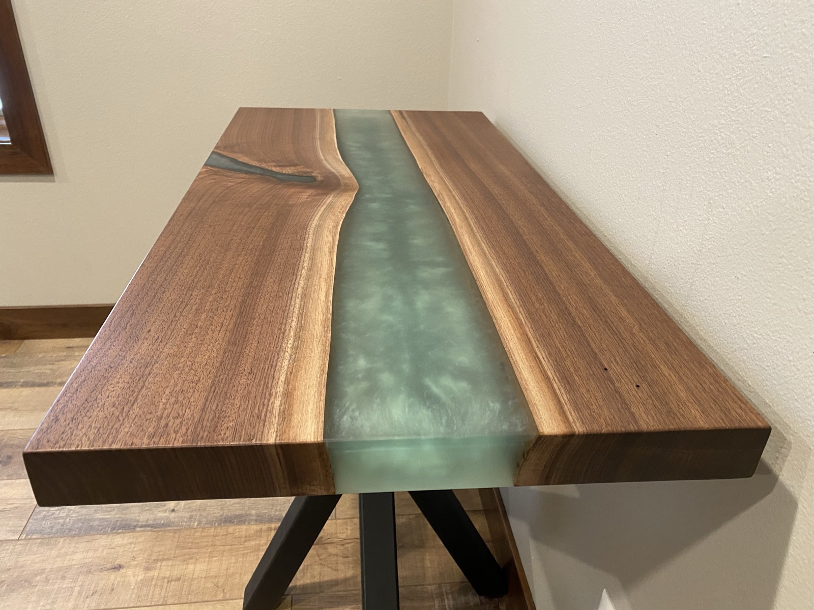 Close-up of the walnut and green epoxy river top showing grain detail
