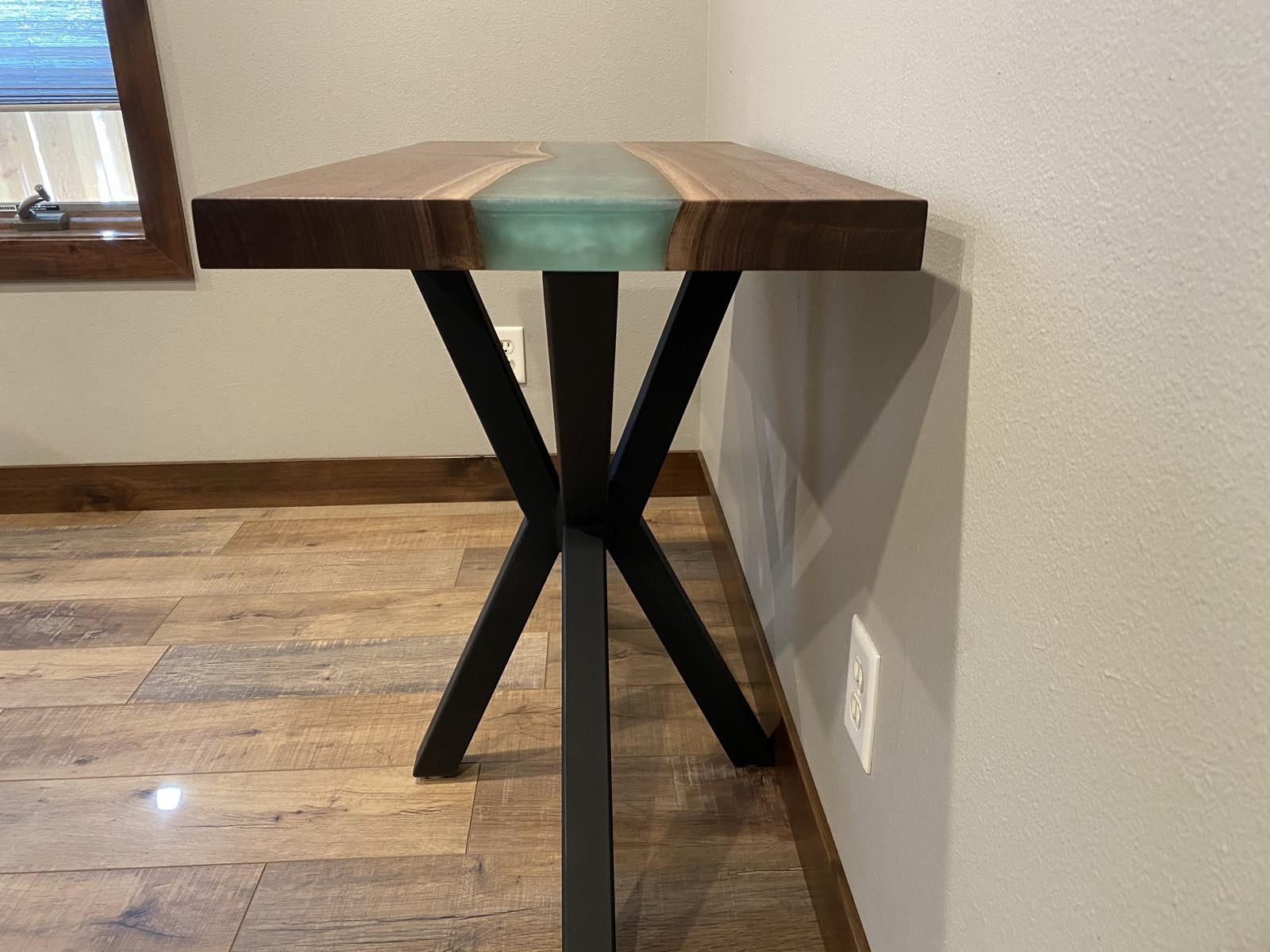 End view of the side table showing the X-base and epoxy river