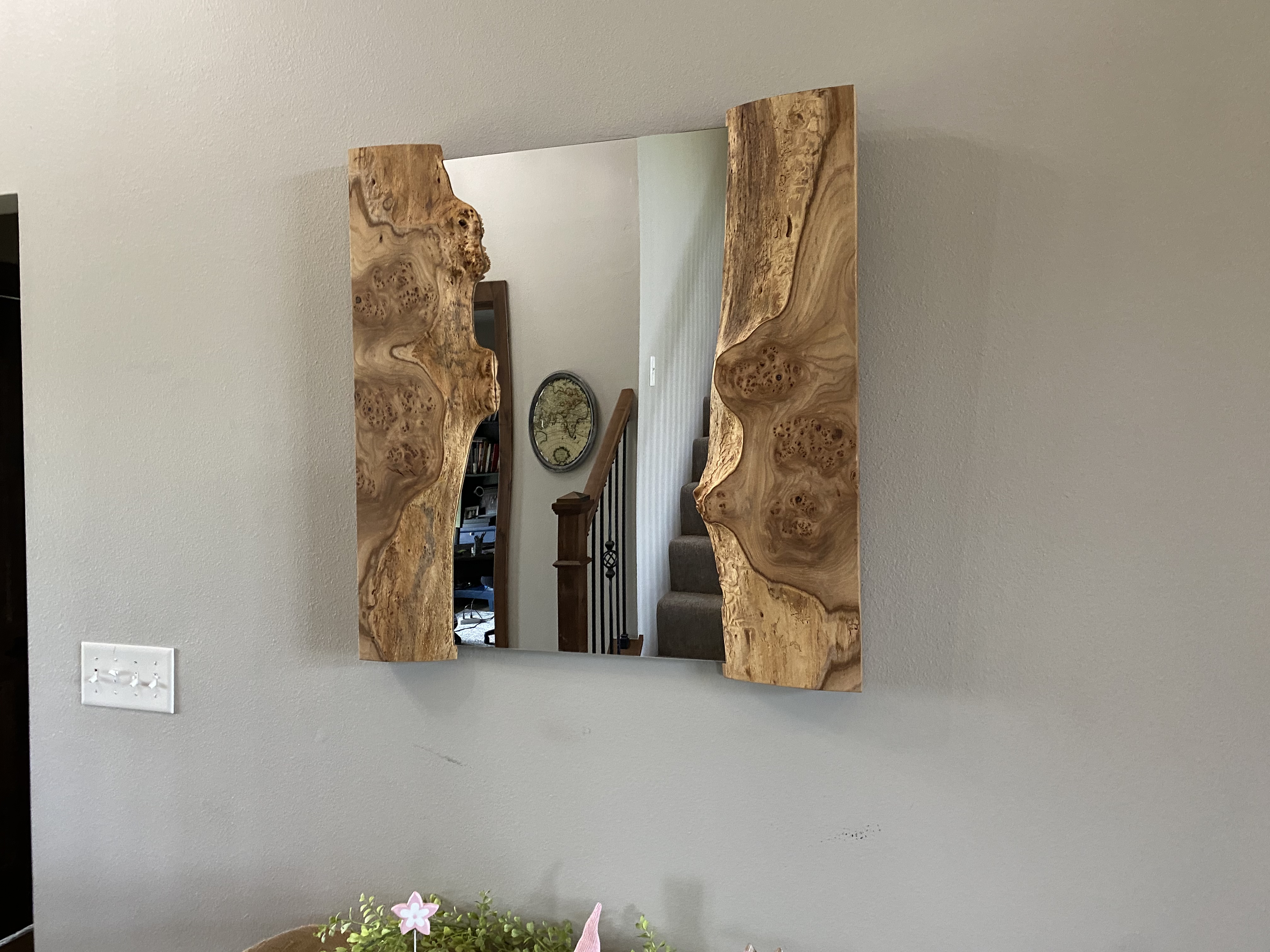 Finished slab mirror on wall showing birds-eye maple flanking the mirror glass