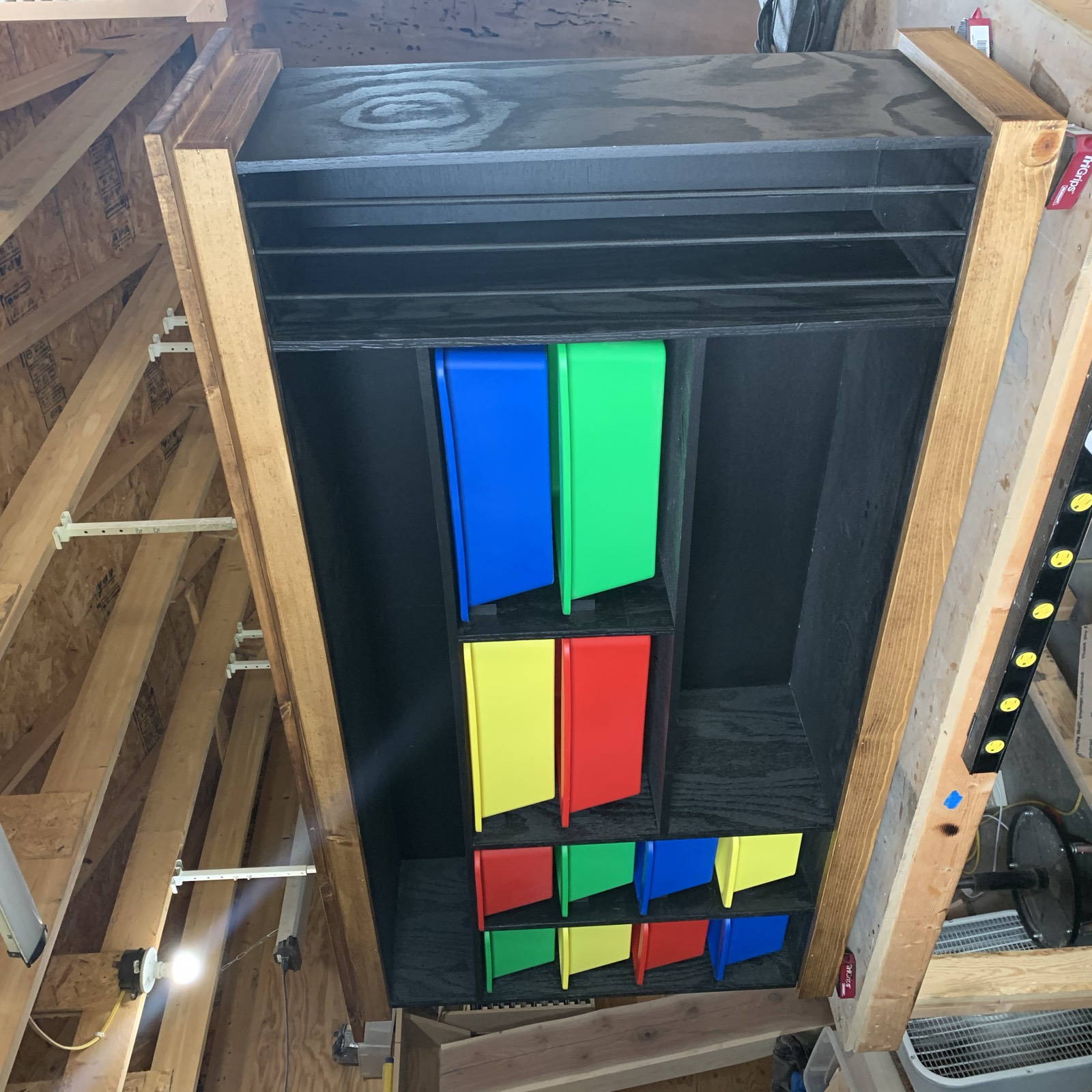 Finished toy storage shelf with colorful bins in different sizes