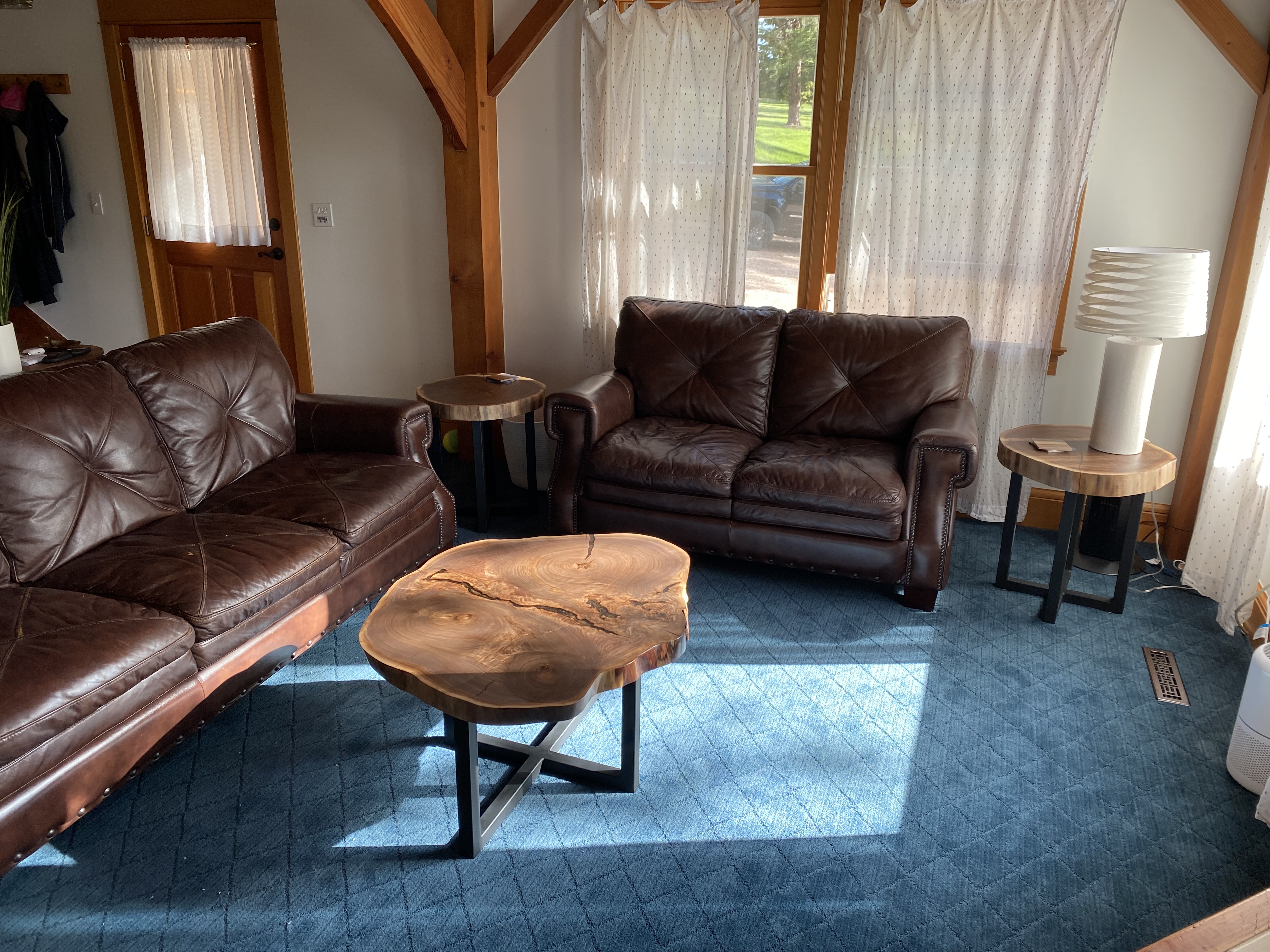 Full set in the living room — coffee table and two end tables with matching walnut slabs