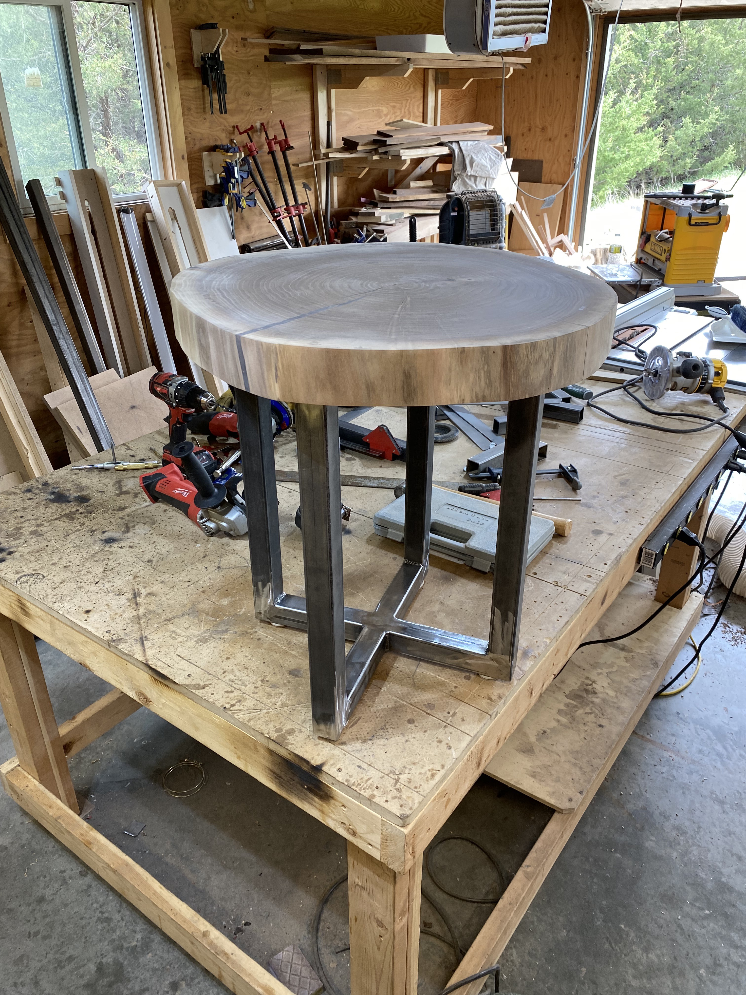 Welded steel base for the end table upside-down in the workshop