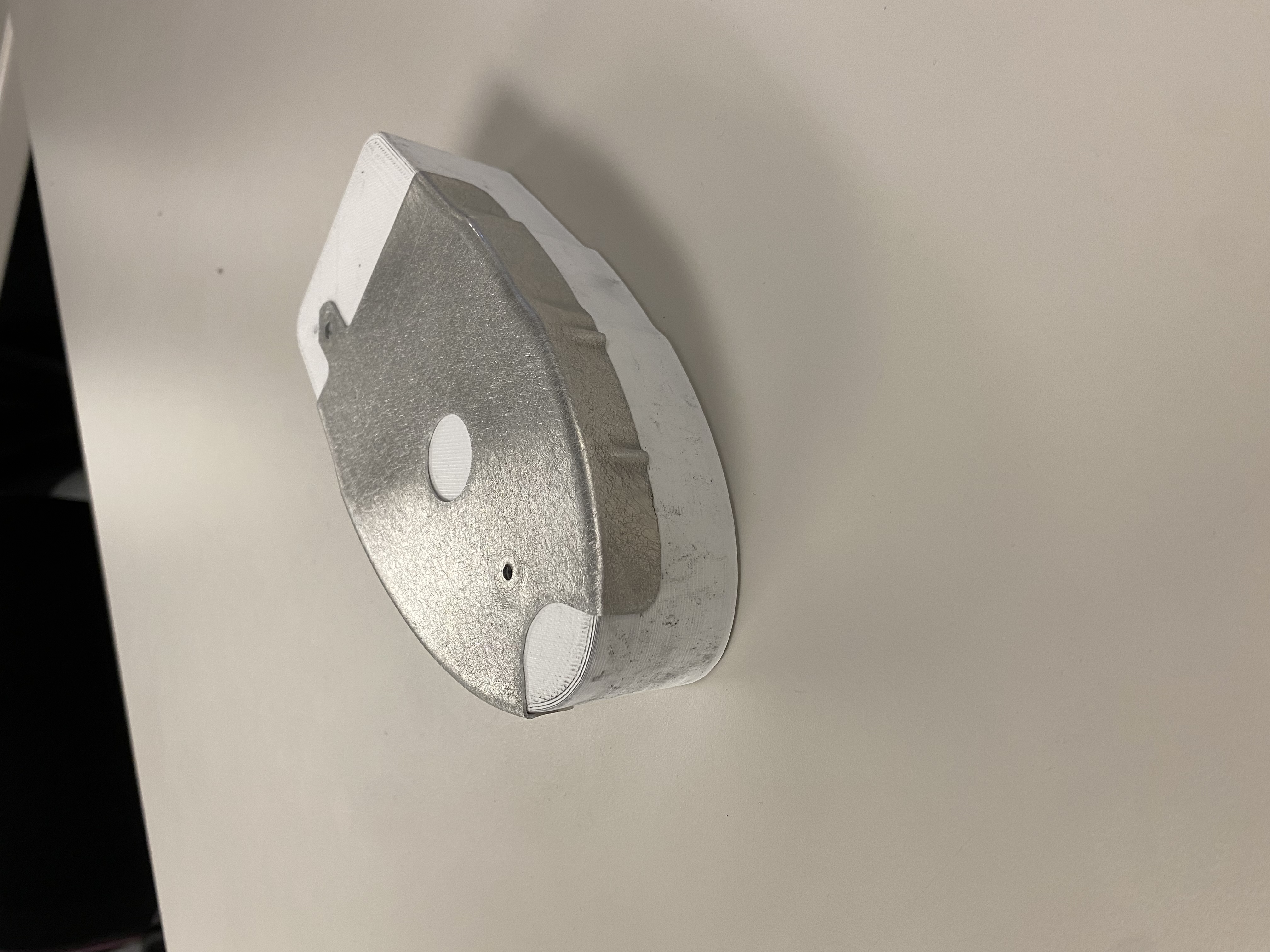 Underside of the formed aluminum rib showing the relief cutout geometry on the mandrel