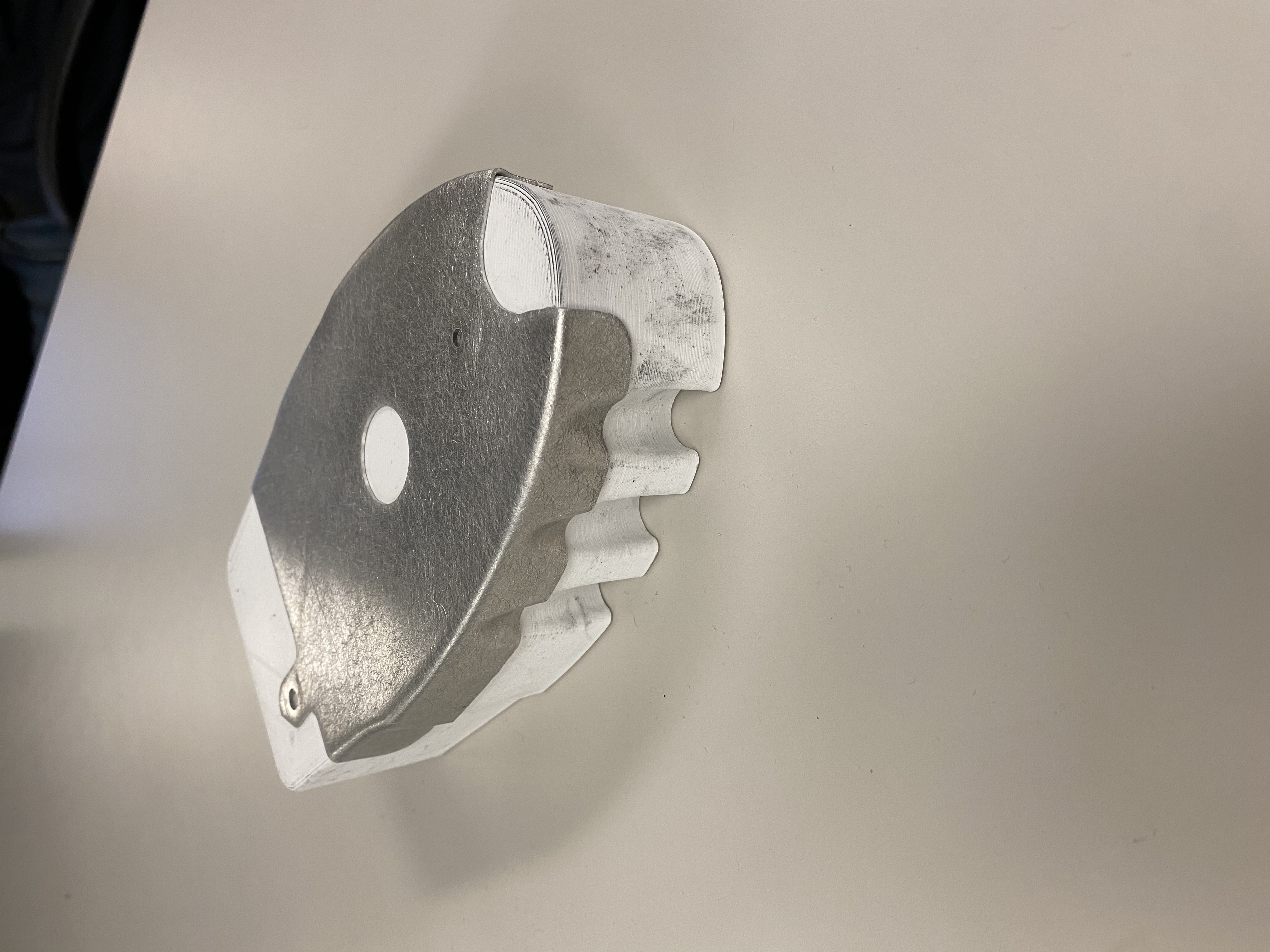 Hydroformed aluminum aircraft rib on 3D-printed tooling showing wrinkle relief cutouts